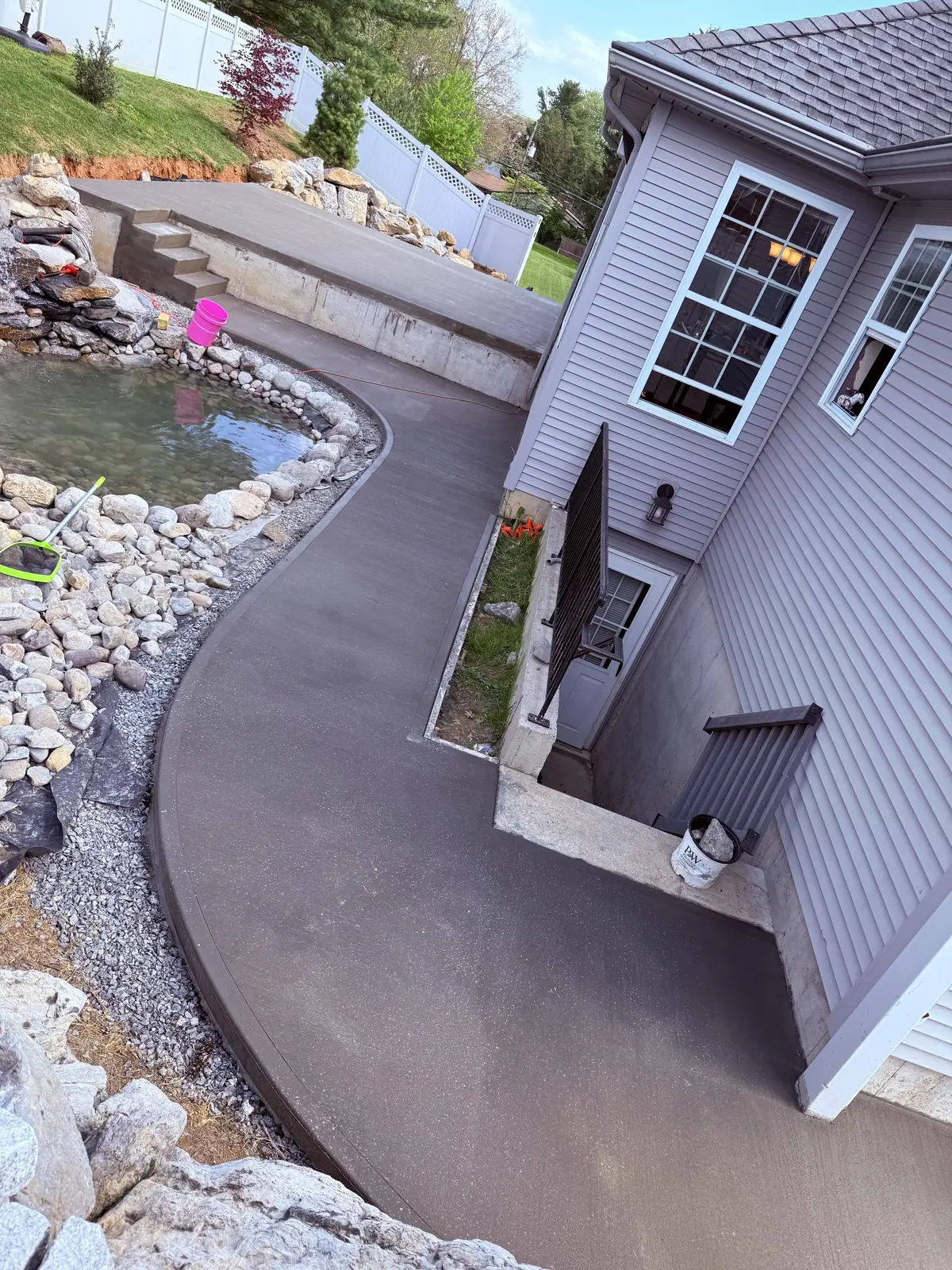 Custom backyard concrete patio with a curved walkway poured by Murray General Contracting in the Lehigh Valley